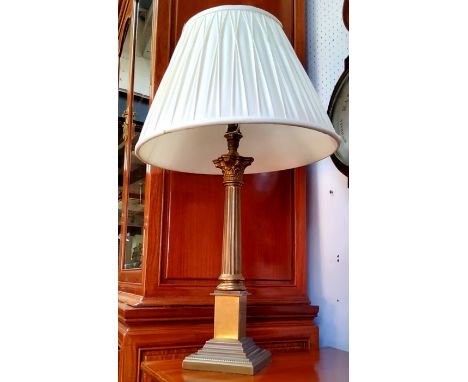 A Corinthian column table lamp with fluted ivory coloured shade 