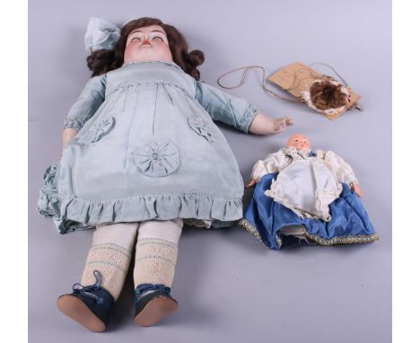 An Armand Marseille bisque headed doll, No 370, with go to sleep eyes, 20" long, and a souvenir doll with ceramic head