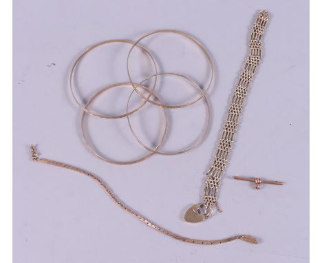 A collection of 9ct gold, including a gate link bracelet (damages) with heart-shaped clasp, four bangles and a T-bar, 48g