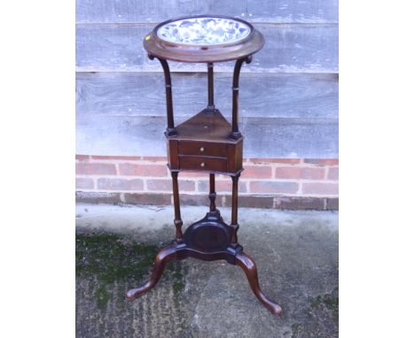 A Georgian design basin stand with black and white bowl, on tripod splay supports