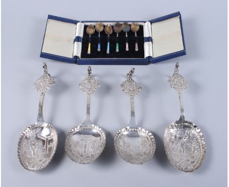 A set of four Dutch silver spoons, each decorated with village scenes with lion scrolled handles, 7.3oz troy approx, and a se