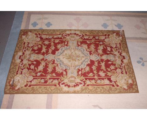 A needlepoint panel of mid 18th century design, on a red ground, 29" x 46" approx