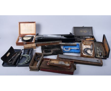 An assortment of scientific instruments, including a cable tensiometer, a tripod, mixed clamps, spirit levels and other items