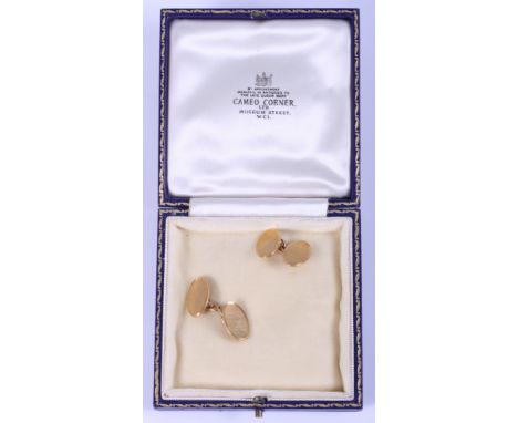 A pair of 18ct gold oval cufflinks, 8.5g, and a pair of 9ct gold cufflinks with engine turned decoration, 7g