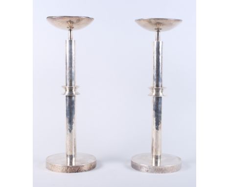A pair of white metal candlesticks with planished decoration, marked 925, with white enamel on copper sconces, 16" high, 104.