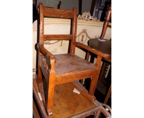 A child's 19th century elm and oak panel seat rocking chair