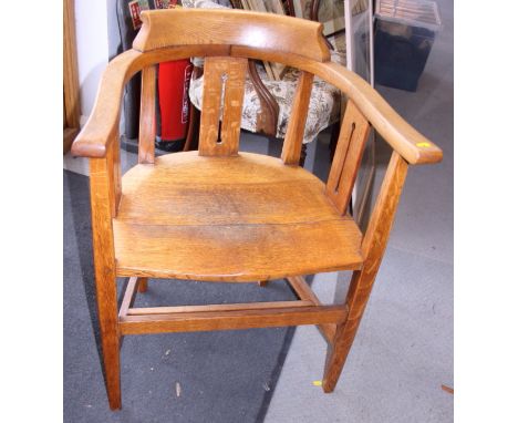 An Arts &amp; Crafts oak panel seat armchair, on square tapered supports