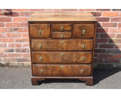 A 19TH CENTURY OAK AND WALNUT CHEST OF DRAWERS, with an unusual arrangement of four smaller drawers above three longer gradua