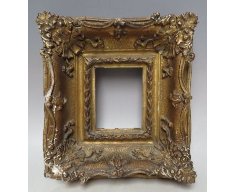 A 19TH CENTURY GOLD SWEPT PORTRAIT MINIATURE FRAME, frame W 8 cm, rebate 11 x 9 cm