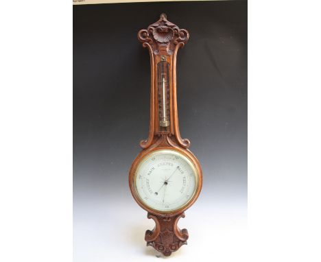 AN EARLY TWENTIETH CENTURY OAK CARVED BAROMETER,  with unusual thermometer scale, H 80 cm