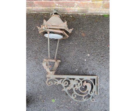 A CAST IRON EXTERIOR  / COURTYARD LANTERN ON WALL BRACKET, with copper hood, approx. overall H 98 cm, W 53 cm