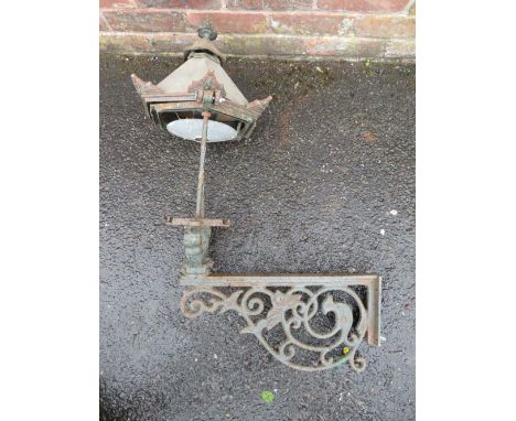 A CAST IRON EXTERIOR  / COURTYARD LANTERN ON WALL BRACKET, with copper hood, approx. overall H 98 cm, W 53 cm
