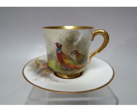 A ROYAL WORCESTER HAND PAINTED COFFEE CAN AND SAUCER, signed Jas Stinton, both items with game bird and gilded decoration, sa