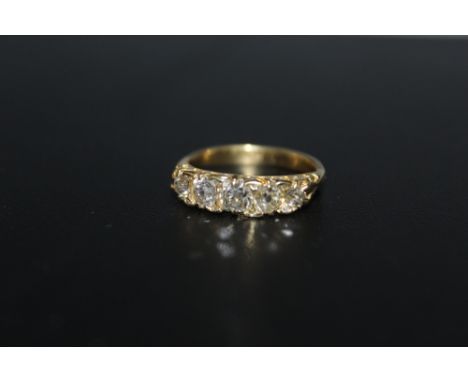 AN 18CT OLD CUT FIVE STONE DIAMOND RING, the five stones total an estimated 1.25 carats but there are also some additional ti
