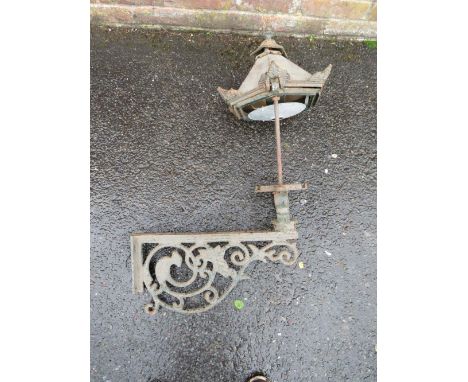 A CAST IRON EXTERIOR  / COURTYARD LANTERN ON WALL BRACKET, with copper hood, approx. overall H 98 cm, W 53 cm