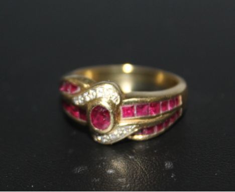 A RUBY AND DIAMOND CLUSTER RING, set in yellow metal stamped 750, approx weight 6.8g, ring size O 1/2