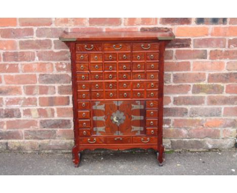 A CHINESE HARDWOOD APOTHECARY CHEST OF SLIM PROPORTIONS, having an arrangement of forty four drawers and two door cabinet, wi