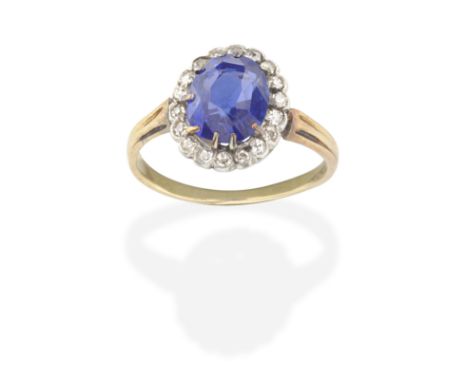 SAPPHIRE AND DIAMOND CLUSTER RINGThe oval-cut sapphire  within a cushion-shaped diamond surround, sapphire approx. 3.25cts, r