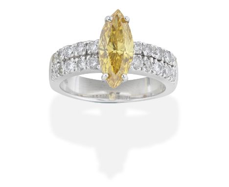 FANCY COLOURED DIAMOND AND DIAMOND RINGThe marquise-cut Fancy Intense Orange-Yellow diamond, weighing 1.50 carats, between tw