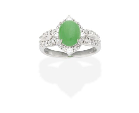 JADE AND DIAMOND RINGThe oval jadeite jade double cabochon within a brilliant-cut diamond surround, between similarly-cut dia