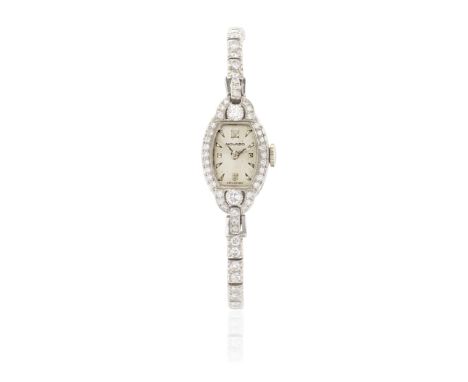 MOVADO: DIAMOND DRESS WATCHThe barrel-shaped dial with Arabic, stud and dart hourmarkers, within a brilliant-cut diamond beze