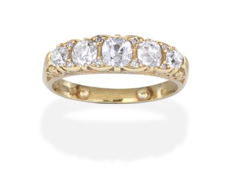 DIAMOND FIVE-STONE RING, 1976Set with five graduating cushion-shaped diamonds, with single-cut diamond accents, the gallery o