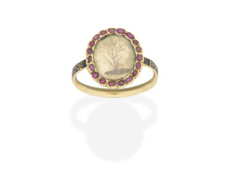 RUBY AND ENAMEL-SET MEMORIAL RING, CIRCA 1770The glazed compartment with hairwork depicting a tree, within a surround of tabl