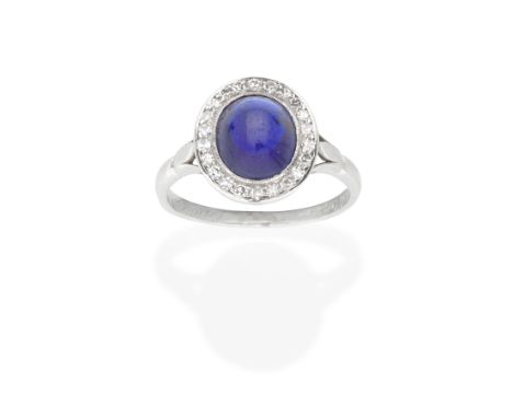 SAPPHIRE AND DIAMOND CLUSTER RING, MID 20TH CENTURYThe oval-cut sapphire cabochon within a single-cut diamond surround, betwe