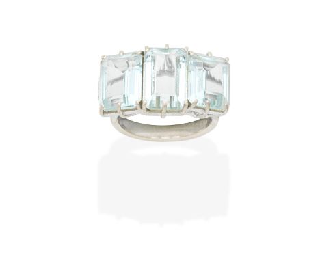 AQUAMARINE AND DIAMOND RINGThe three step-cut aquamarines, between brilliant-cut diamond shoulders, one diamond deficient,  r