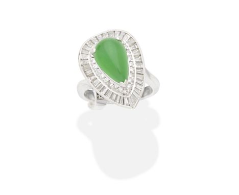 JADE AND DIAMOND RINGThe pear-shaped jadeite jade double cabochon within a surround of brilliant-cut diamonds and an undulati
