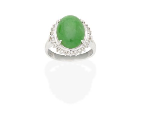 JADE AND DIAMOND RINGThe oval jadeite jade cabochon within a brilliant-cut diamond surround, ring size approx. N½ Footnotes:A