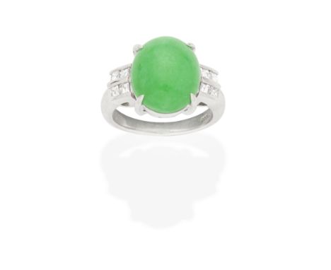 JADE AND DIAMOND RINGThe oval jadeite jade double cabochon between two row square-cut diamond shoulders, diamonds approx. 0.4