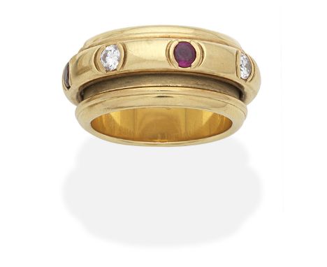 PIAGET: RUBY AND DIAMOND 'POSSESSION' RING, CIRCA 1991The rotating central band set with alternating circular-cut rubies and 