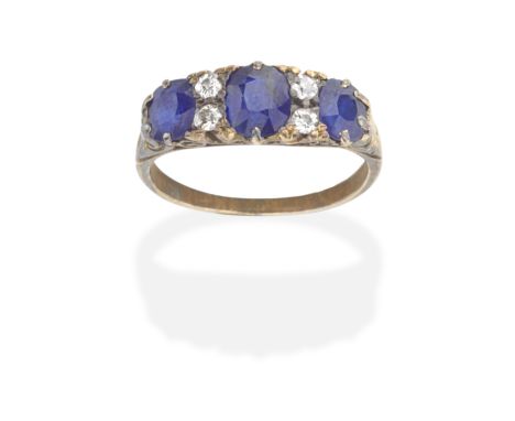 SAPPHIRE AND DIAMOND RINGThe cushion-shaped sapphires alternating with duos of cushion-shaped diamonds, the gallery of scroll