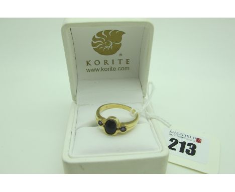 Korite; A Modern 14ct Gold Canadian Three Stone Ring, oval and circular collet rubover set, also stamped "14K" (finger size U