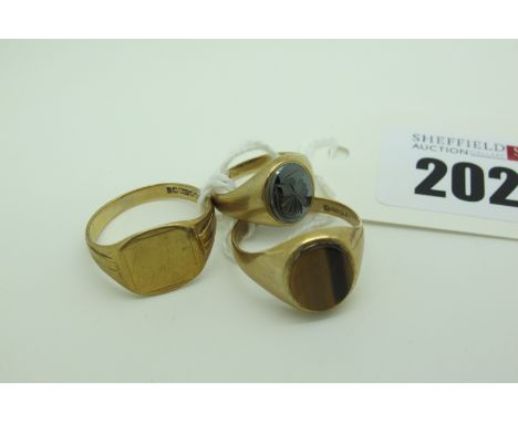A 9ct Gold Signet Style Ring, (finger size S); A 9ct Gold Tiger's Eye Gent's Ring, (finger size S); A Smaller 9ct Gold Ring, 