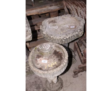 Two cast bird baths on cherub and tree trunk supports, 17" high