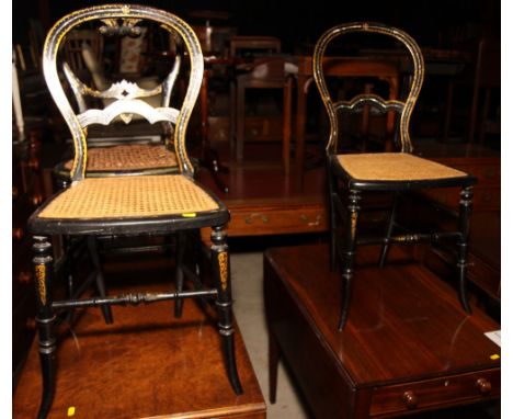 A pair of ebonised balloon back cane seat occasional chairs decorated in gilt and mother-of-pearl and a similar chair