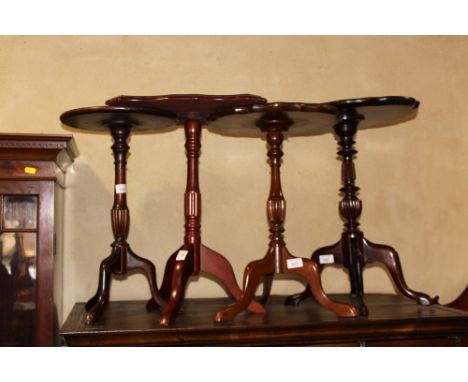 A mahogany wine table with shaped edge, two other wine tables and a similar square shape top occasional table, on tripod base