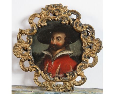 A 19th Century oil on copper, portrait of a cavalier, 3 1/2" dia, in gilt metal open scrollwork frame