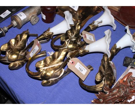 A set of four gilt metal and glass curtain tie backs formed as lilies, 12" high (one damaged)