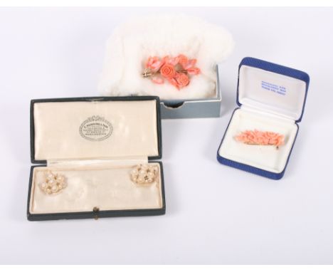 A carved pink coral floral brooch with gold mount, a similar carved coral floral brooch and a pair of seed pearl drop earring