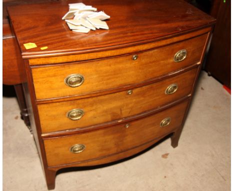 A 19th Century mahogany bowfront chest of three drawers with oval brass handles, on cut away bracket supports, 33" wide