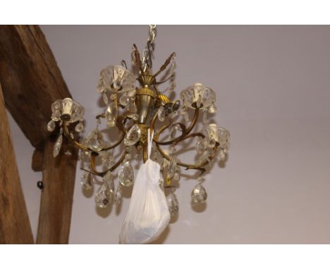 A gilt metal six-branch chandelier with cut glass teardrops