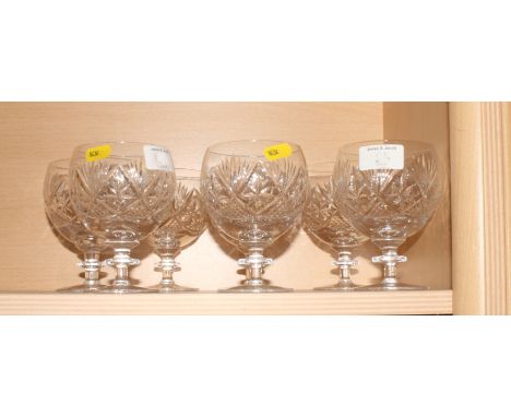 A moulded glass punch bowl with eighteen punch cups and a ladle and a set of seven crystal wine goblets