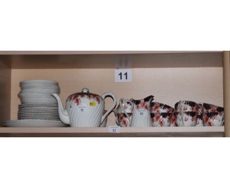 An early 20th Century bone china Imari decorated part tea service