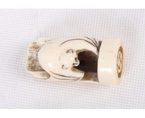 A Japanese carved bone seal netsuke with bat and bamboo design, 2" high, and a Middle Eastern painted bone bracelet with figu