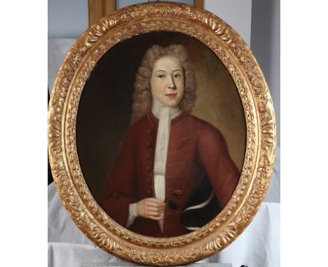 An English mid 18th Century oval oil painting, portrait of a Georgian gentleman holding a rose and a tricorn hat under his ar