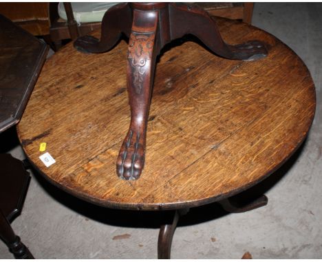 A Georgian oak circular tilt top occasional table, on vase turned pillar and tripod base, 29" dia