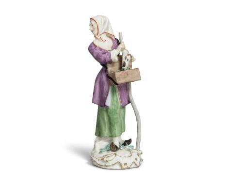 A Meissen 'Cris de Paris' figure of a crier with a marmot, circa 1755Modelled by Peter Reinicke, pulling the animal from a bo